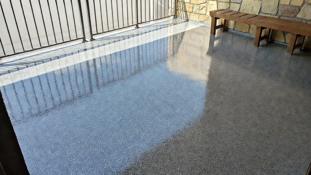 Professional epoxy pool deck coating with custom flake finish in outdoor patio setting